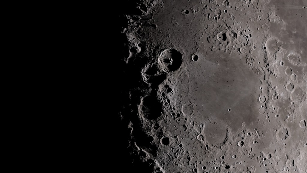 slide 2 - Image of the Moon with deep shadows