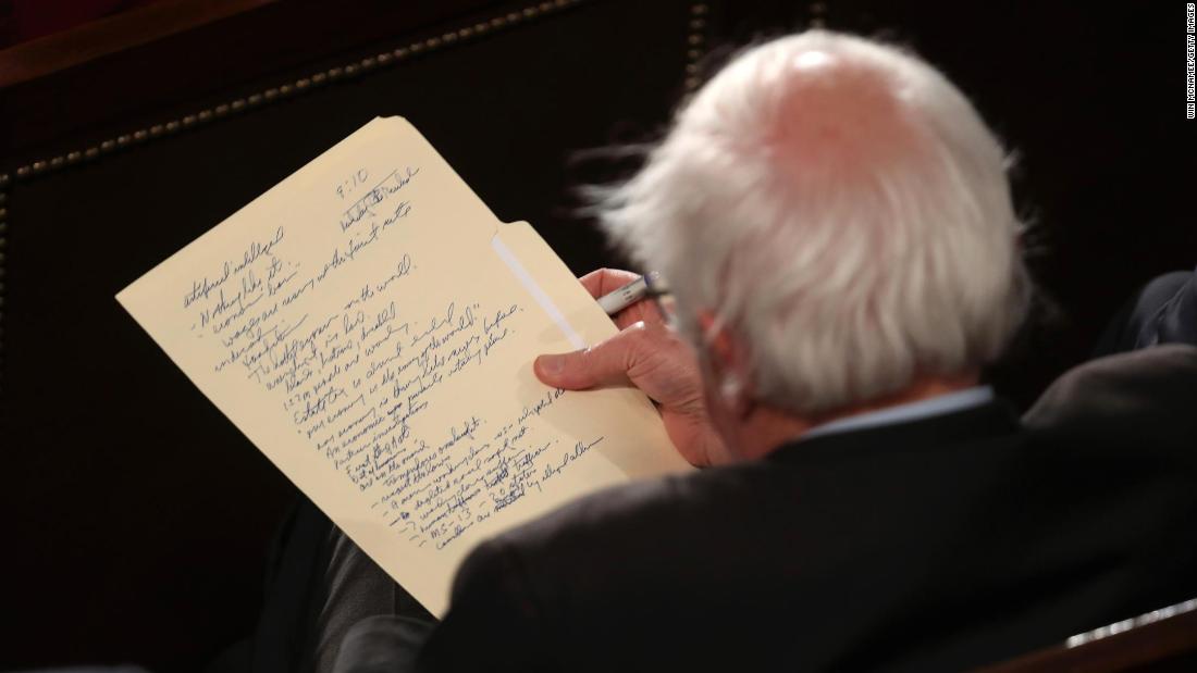 Sanders looks at his notes as he watches President Trump deliver the State of the Union address in February 2019. That month, Sanders announced that he would be running for president again.