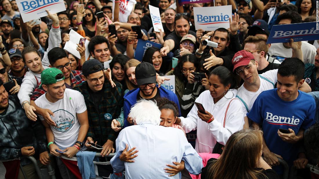Sanders hugs a young supporter during a campaign rally in Los Angeles in March 2019.