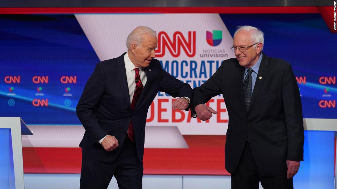 Biden greets Sanders with an elbow bump before the start of a debate in Washington in March 2020. They went with an elbow bump instead of a handshake because of the coronavirus pandemic.