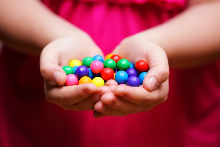 Child Holding Colorful Gum Balls